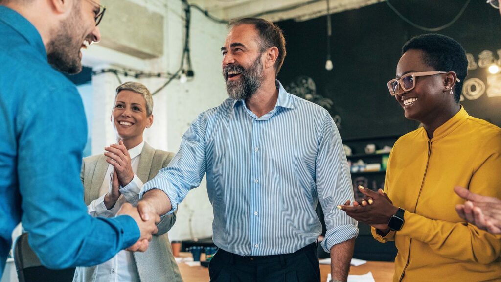 A group of people looking happy in a business setting