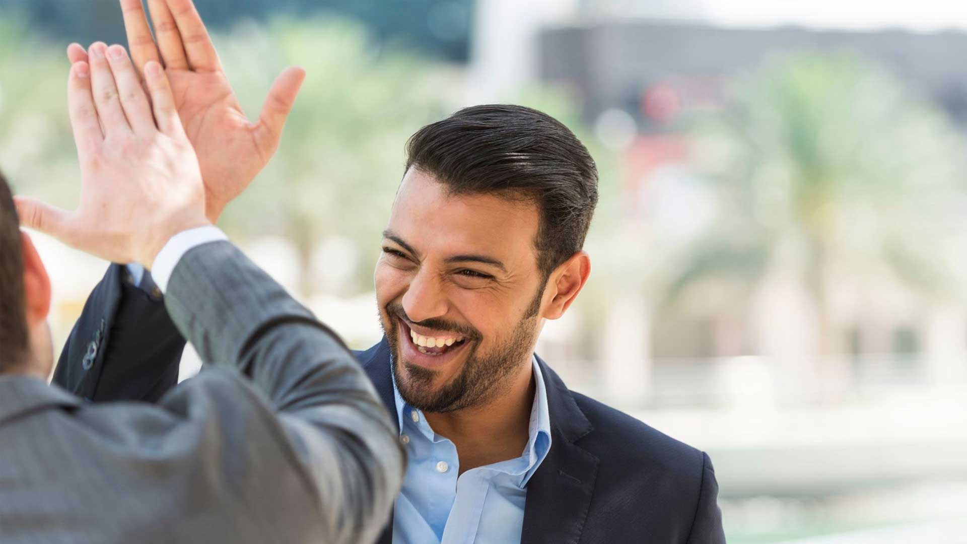 Two men high fiving