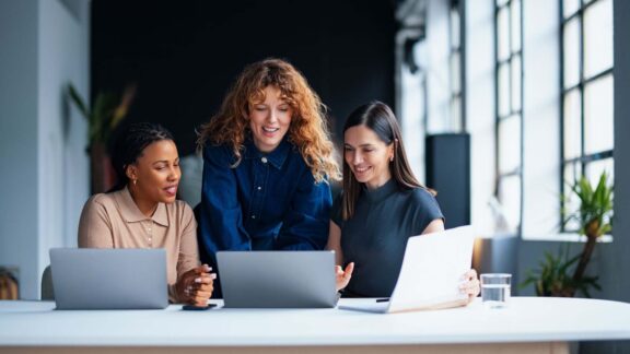Three women with laptops