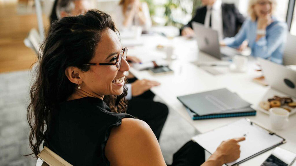 business woman laughing at table