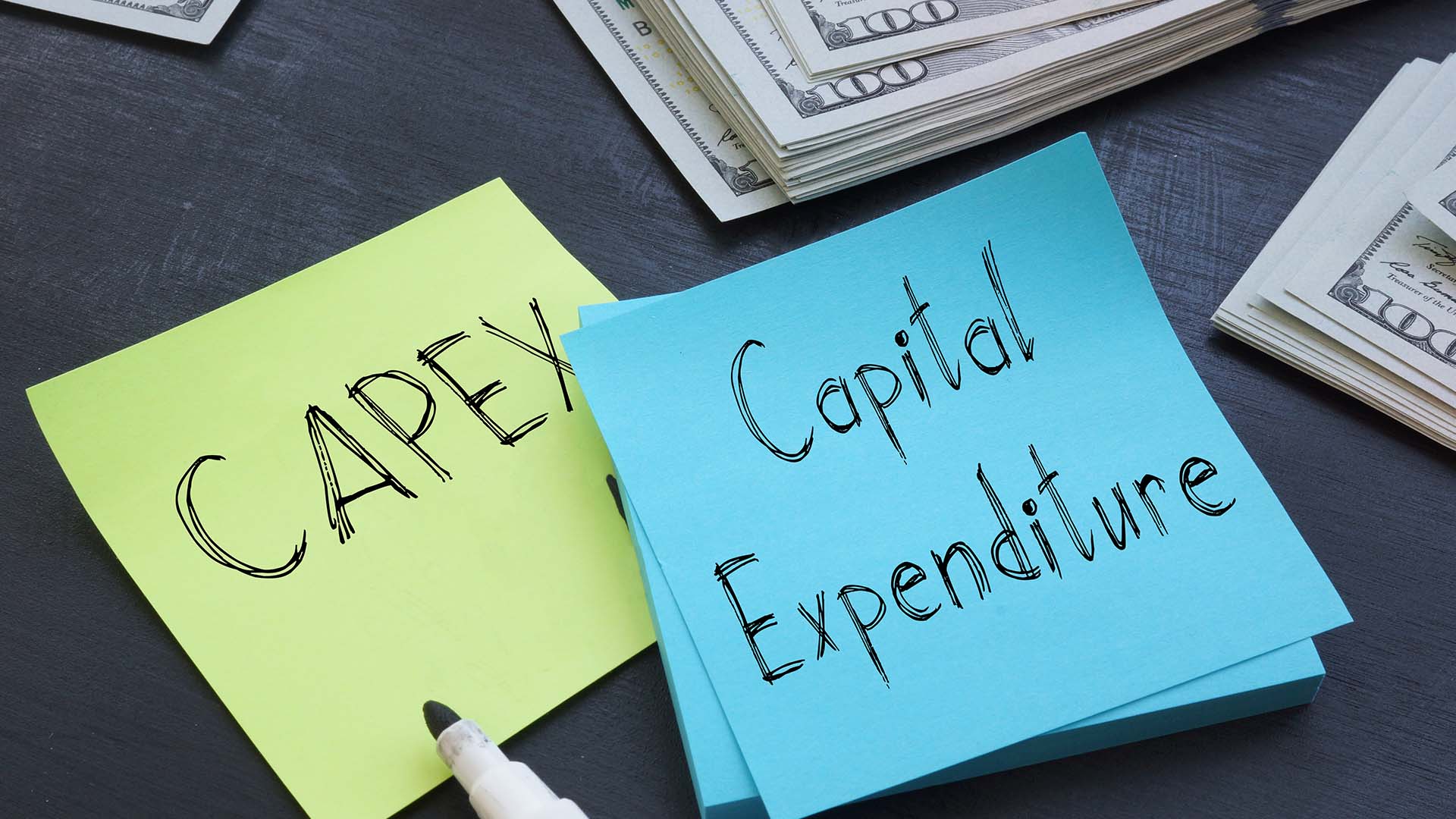 Post-It notes with the words "CAPEX" and "Capital Expenditure" written on them in marker.