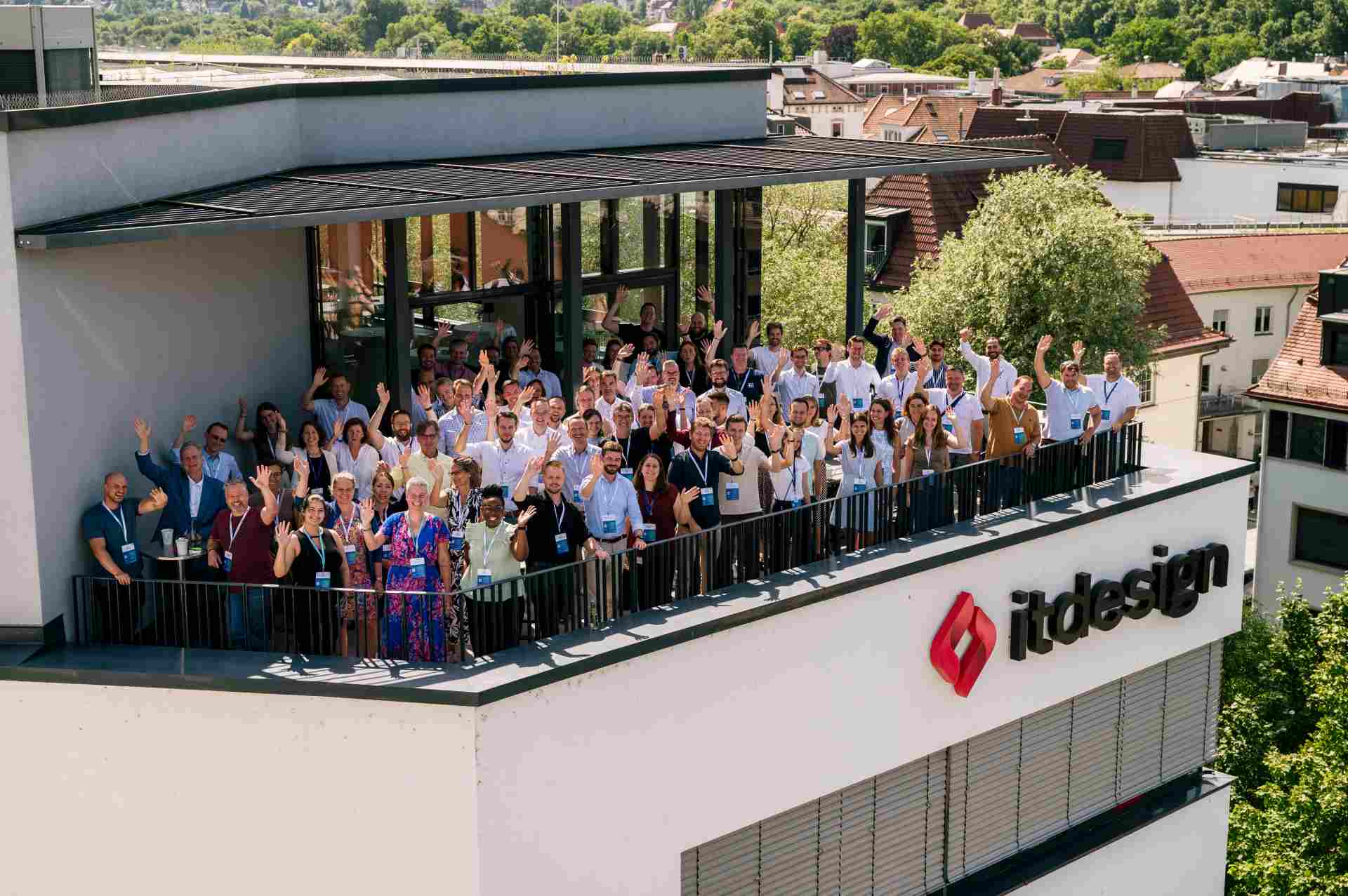 Many people standing on the balcony of the itdesign building